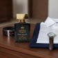 Fresh woody cologne displayed beside a tailored navy blazer, leather belt and classic wristwatch