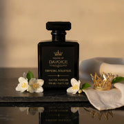 Crystal Solstice perfume 100 mL inspired by Baccarat Rouge perfume displayed on a black stone with gold crown