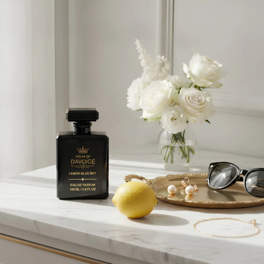 House of DaVoice Lemon Blue Sky Women's Citrus Perfume displayed on a luxury dresser with elegant accessories inspired by Dolce and Gabbana Light Blue Women's Perfume