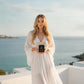 Woman holding House of DaVoice Lemon Blue Sky perfume inspired by Dolce and Gabbana Light Blue Perfume for Women overlooking the Mediterranean coast