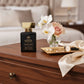 House of DaVoice Nuclear Flower women's floral perfume displayed on a luxury dresser inspired by Victor and Rolf Flowerbomb