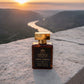 House of DaVoice Santal Horizon overlooking a peaceful river valley, unisex sandalwood fragrance that smells like Santal 33