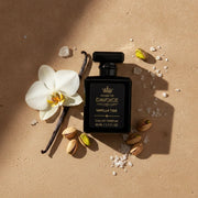 A perfume bottle labeled 'House of DaVoice Vanilla Tide Eau de Parfum' is arranged on a warm beige surface with a white flower, vanilla bean, pistachios, and sea salt scents