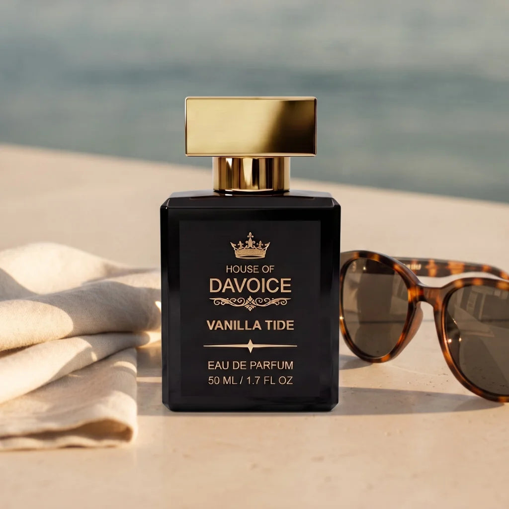 Vanilla Tide luxury perfume beside sunglasses and linen near the ocean